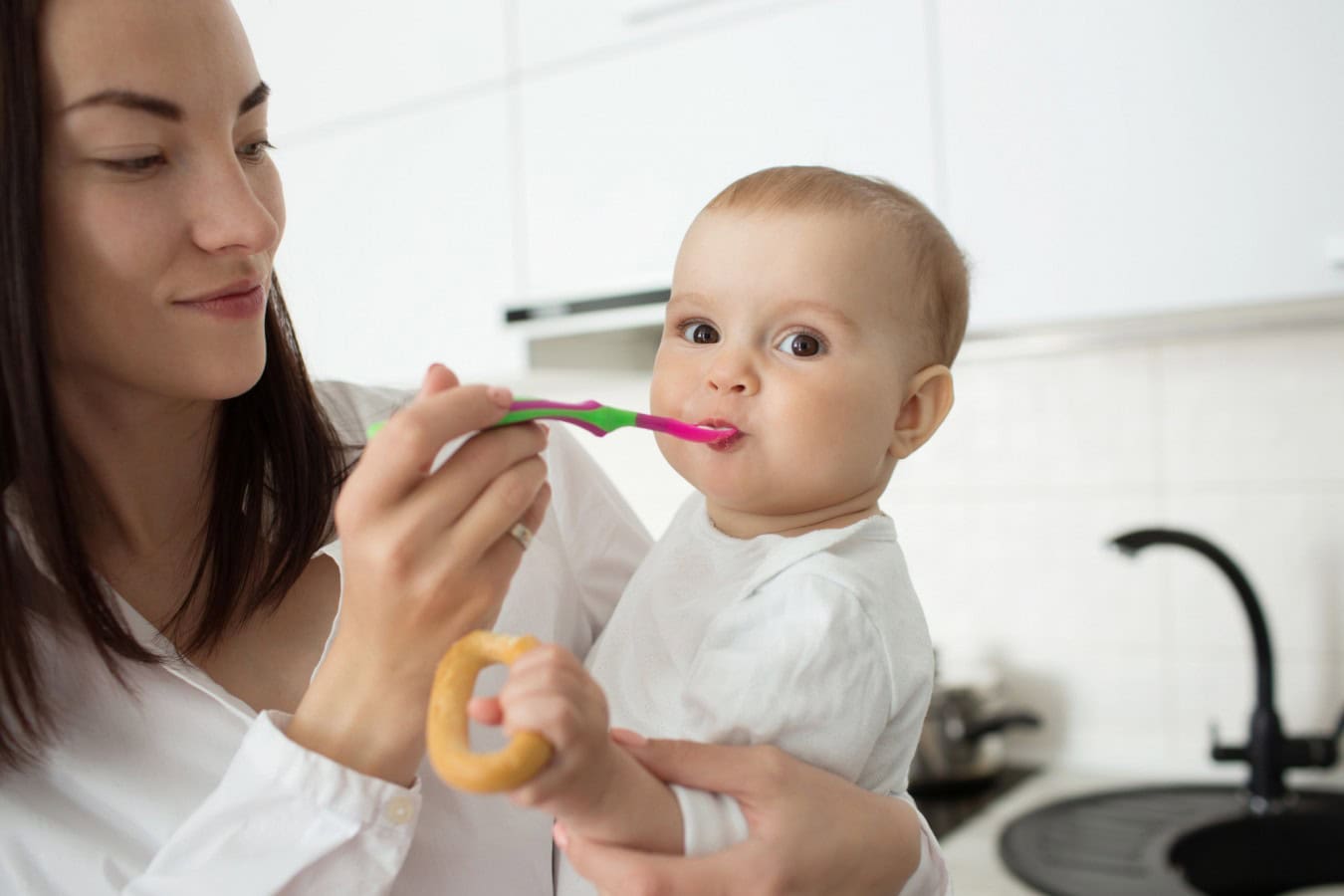 mother feed cute baby with spoon scaled mother feed cute baby with spoon
