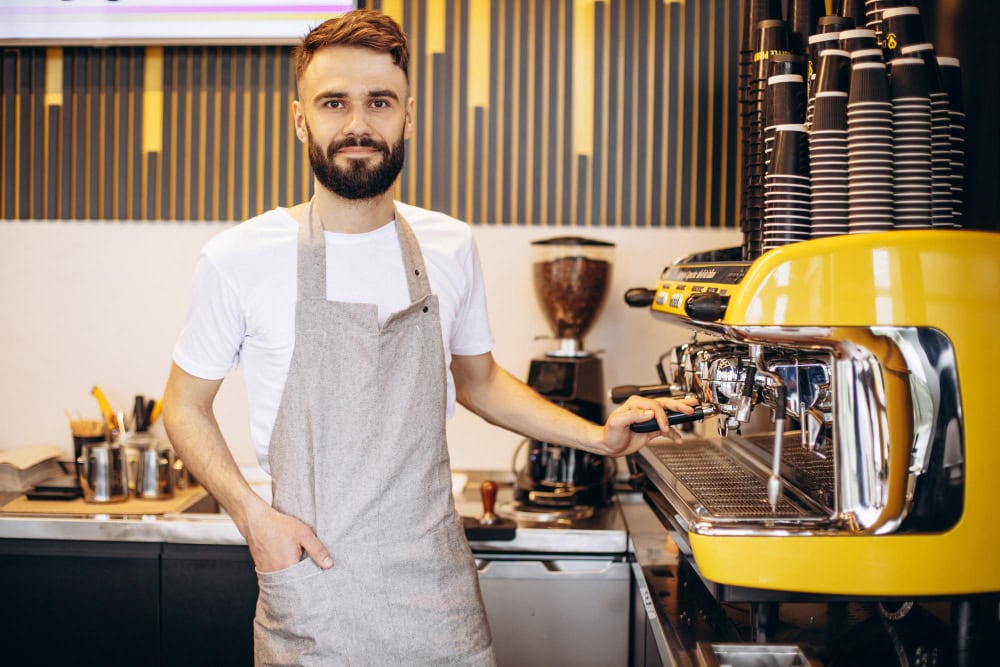 young male barista working coffee house
