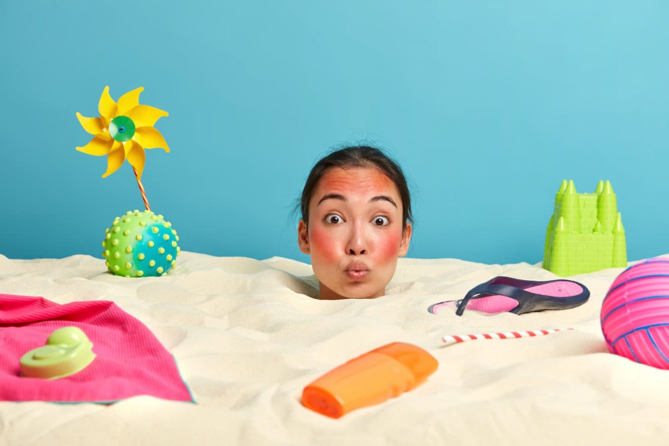young woman head with sunscreen cream face surrounded by beach accessories scaled young woman head with sunscreen cream face surrounded by beach accessories