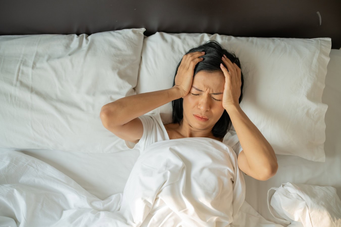unhappy exhausted mature woman with closed eyes lying bed touching temples close up tired female suffering from headache migraine feeling unwell suffering from insomnia lack sleep scaled A Vitamini Eksikliği Nasıl Anlaşılır